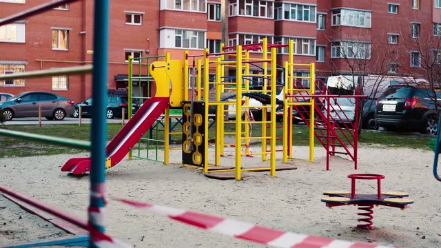 An empty abandoned playground fenced with ribbons in a residential area during quarantine due to the threat of AKA covid-19 coronavirus. Ukraine, Sumy