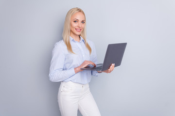 Photo of positive intelligent manager girl hold laptop ready prepare company document search information wear good look pants isolated over gray color background