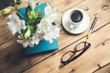 flowers on book  with coffee