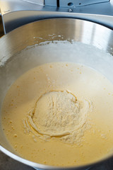 Beating cream for a sweet dessert in a food processor. Cream nozzle