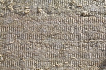 warming the walls of a stone house with a stone wool heater. Ecological insulation of rooms with building a house. Installation of cellulose thermal insulation in the wall of the frame house