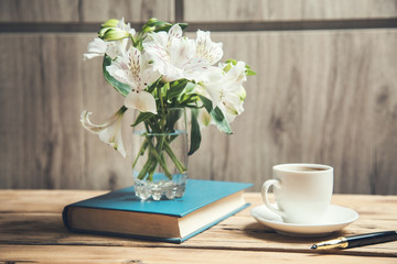flowers on book  with coffee