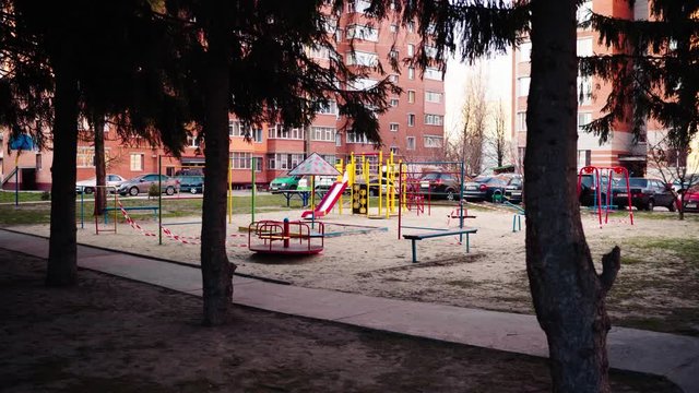 An empty abandoned playground fenced with ribbons in a residential area during quarantine due to the threat of AKA covid-19 coronavirus. Ukraine, Sumy