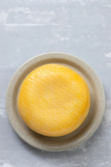 cheese on the small dish on ceramic background