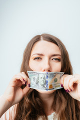 on a gray background young girl with dollars