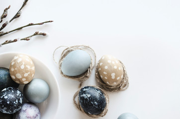 Pastel composition for the holiday of Easter. Colored eggs in natural colors. Background for the presentation of work or text. Top view. Copy space.  Mock-up