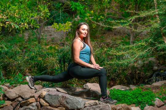 Young woman practicing yoga in the parck