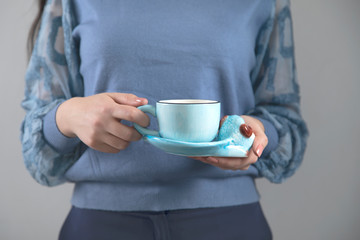 woman hand holding cup of tea