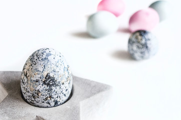 Composition for the holiday of Easter. Painted eggs in natural colors. Background for the presentation of work or text.