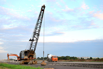 Large crawler crane or dragline excavator with a heavy metal wrecking ball on a steel cable....