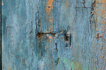 Vintage boards painted with colored paint on the peeling surface. Weathered coating of wood material.