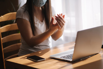 Close up woman hands using sanitizer spray, dispenser at home. Home isolation, quarantine. Coronavirus concept