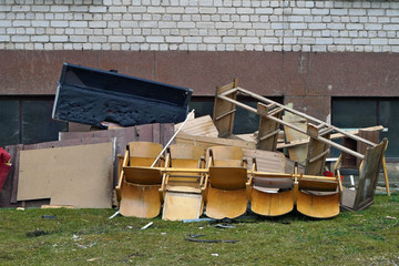 Odl  broken   furniture at the garbage dump near the standard  apartment   building