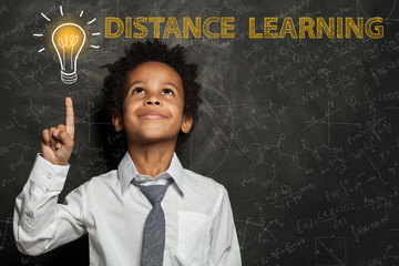 Black child boy with light bulb, science formulas. Distance learning concept
