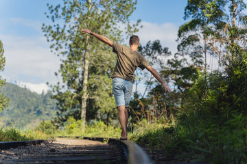 young man are walking on the tracks in Ella. Sri Lanka