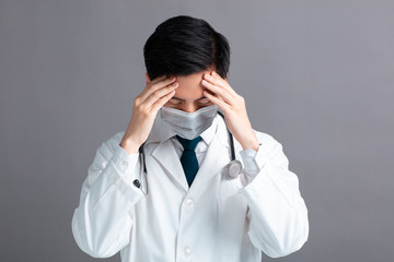 stress and tired young Doctor Wear Medical Mask