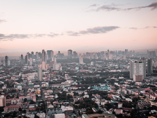Fototapeta na wymiar Aerial Cityscape of Quezon City in Metro Manila, Philippines while sunrise