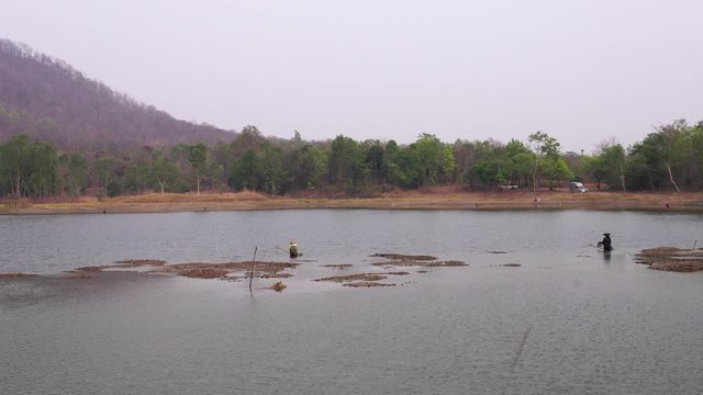 The traditional local fishing method by a device called "Yor" Which is made of bamboo and netting, Villagers fishing during low tide.
