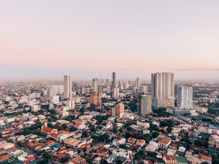 Aerial drone shot of Makati City while sunrise