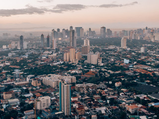 Aerial drone shot of Makati City while sunrise