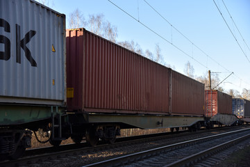 Fototapeta na wymiar Cargo containers transportation on freight train by railway. Coronavirus Wreaks Havoc On Global Industry. Global economy is heading into a recession thanks to the widening fallout from the COVID-19