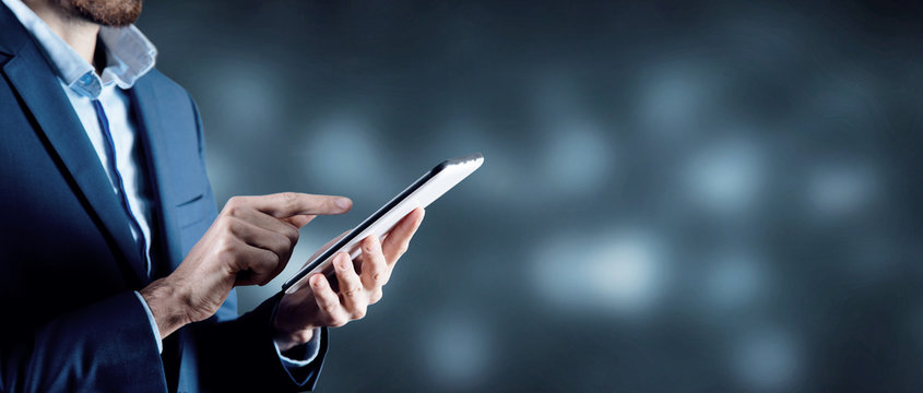 businessman holds tablet in hand