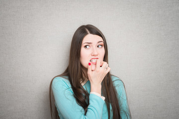 girl worries and bites his nails