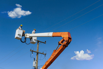 maintenance of electricians work with high voltage electricity on the hydraulic bucket