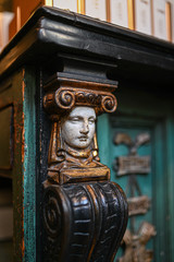 Old wooden pillar with human face