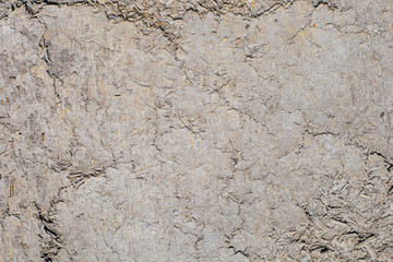 Texture of the wall of an old wooden house made of clay and straw.