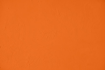 Saturated orange colored low contrast Concrete textured background with roughness and...