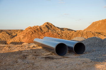 Sections of pipe on top of wooden supports at an construction site for natural gas. Construction...