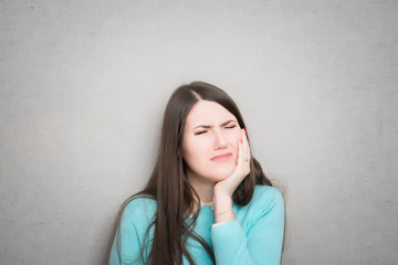 Gorgeous female model suffering bad toothache closeup