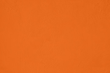 Saturated orange colored low contrast Concrete textured background with roughness and...