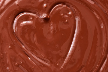 Melted chocolate heart background. The texture of liquid dark chocolate.