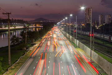 Sunset, beggining the night in metropolis, bright lights and vehicles in transit. Sao Paulo city...