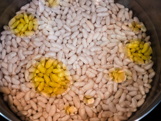 Close view of some white fava beans with oil on it.