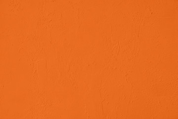 Saturated orange colored low contrast Concrete textured background with roughness and...