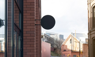 Blank black outdoor round sign mockup brick wall mounted