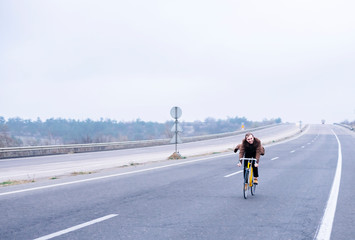 Obraz premium Cyclist riding a bike on an open road