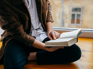 Young man reading a book - 336067730