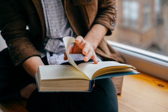 Young Man Reading A Book