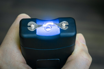 Personal taser for protection against bandits is in the hands. The use of a stun gun with a...
