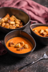 healthy delicious tomato cream soup. Vegetable soup. old tetured background, rustik bowl