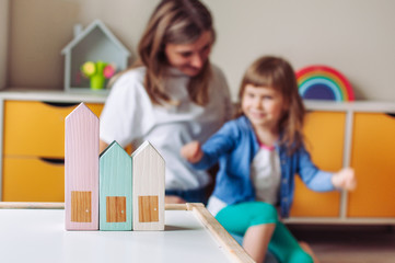 Wooden toy houses on the table in the kids room