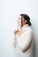 brunette girl praying and looking at the sky on a white background