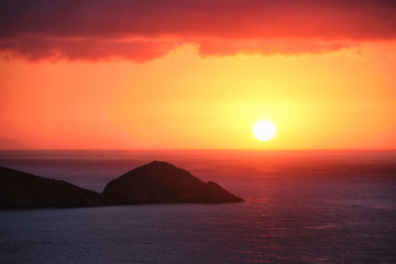 Fototapeta na wymiar Sea sunset. Seascape sunset with island. Sun setting down in sea. Crete island, Greece