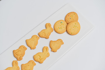 Easter cookies fresh from the oven, the shape of a rabbit, chicken, eggs, perfect shortbread, tasty sweet on a black background