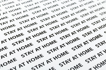 Black plain text on white paper about coronavirus outbreak. Quarantine. Stay at home.