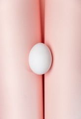 Creative Easter beige and pink background with white eggs.